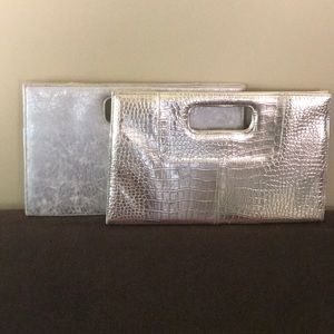 Two large woman’s clutch purses....silver and gold